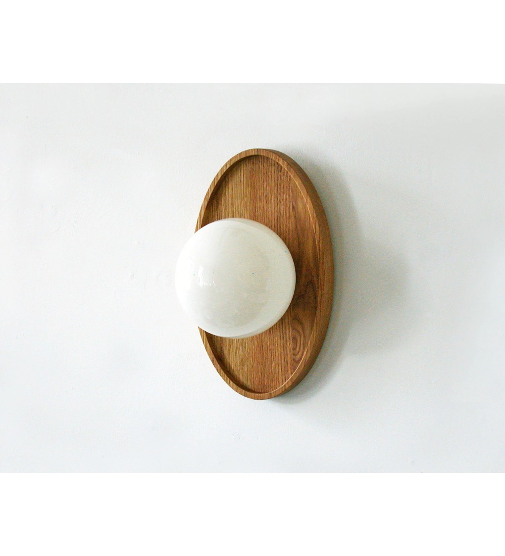 Oval wooden panel and opaline glass globe wall lamp