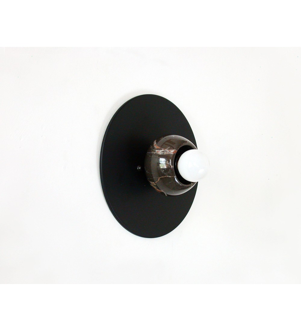 Black round marble cup and white bulb wall lamp